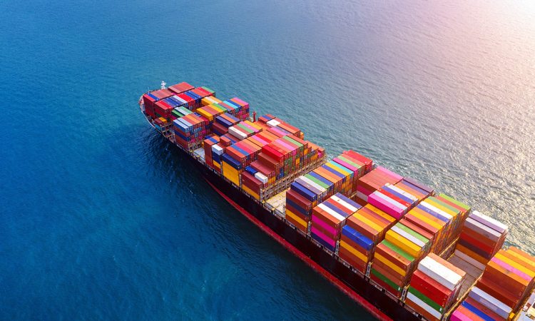 Aerial view of container cargo ship in sea.